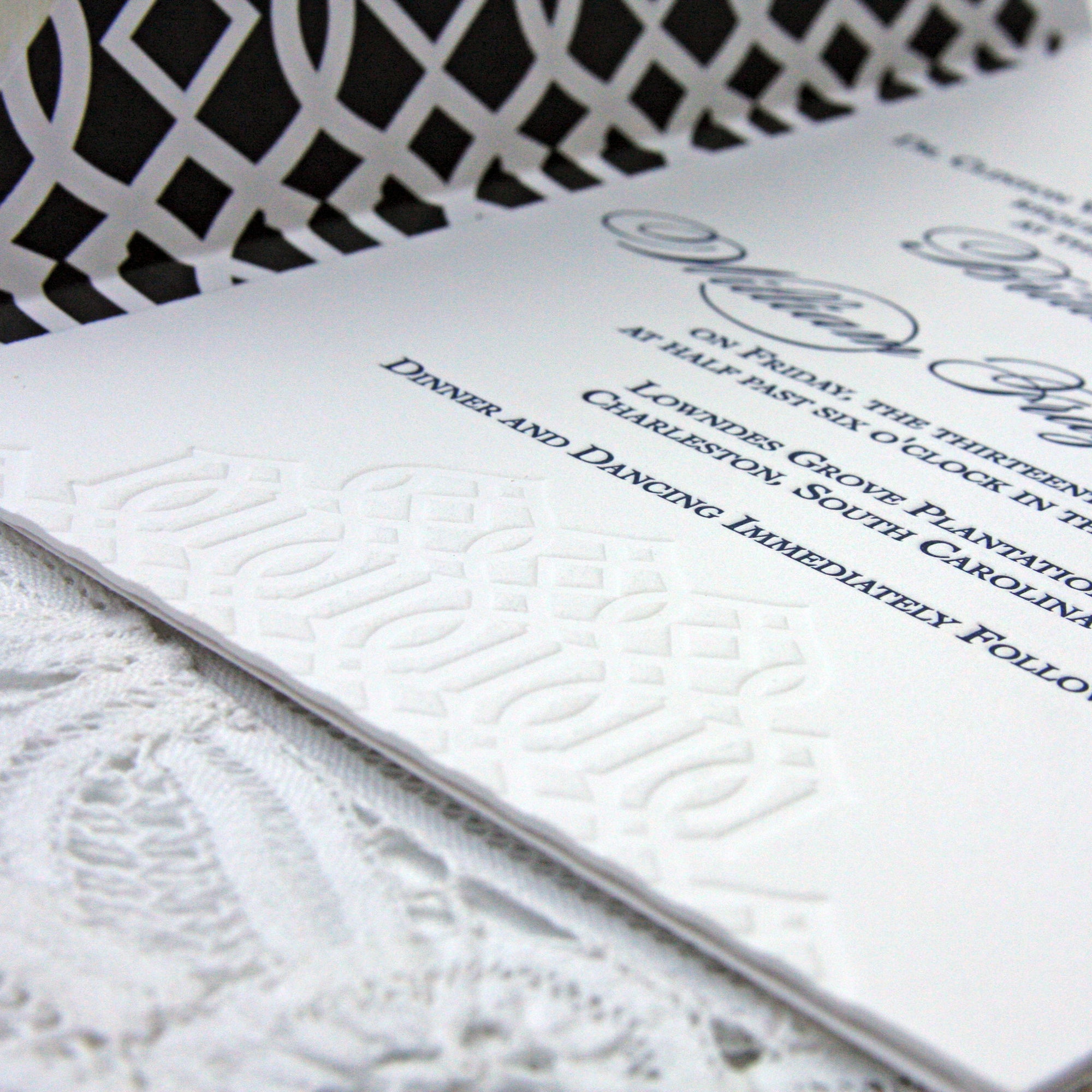 Wedding Invitation with trellis details in a blind impression on the invitation and navy envelope liner