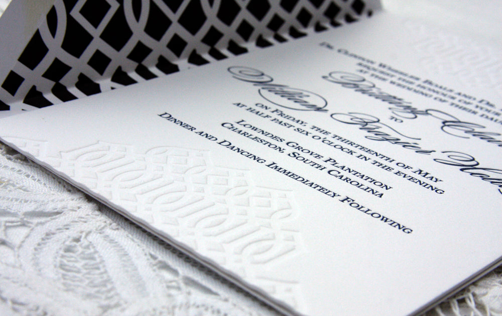 Wedding Invitation with trellis details in a blind impression on the invitation and navy envelope liner